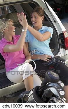 Stock Photograph - women high-fiving. 
fotosearch - search 
stock photos, 
pictures, images, 
and photo clipart