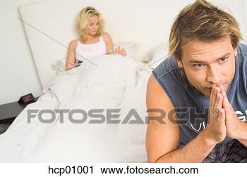 Stock Photography - worried man sitting 
on bed. fotosearch 
- search stock 
photos, pictures, 
images, and photo 
clipart