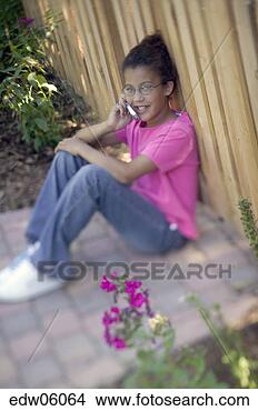 Stock Photo - young african 
girl talking on 
cell phone. fotosearch 
- search stock 
photos, pictures, 
images, and photo 
clipart