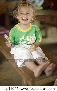 Stock Image - young boy eating. 
fotosearch - search 
stock photos, 
pictures, images, 
and photo clipart