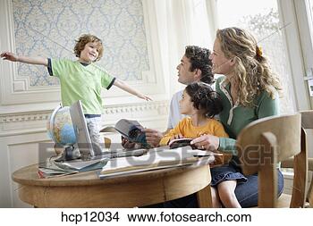 Stock Photo - young boy playing 
as family watches. 
fotosearch - search 
stock photos, 
pictures, images, 
and photo clipart