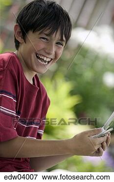 Picture - young boy using 
cell phone. fotosearch 
- search stock 
photos, pictures, 
images, and photo 
clipart