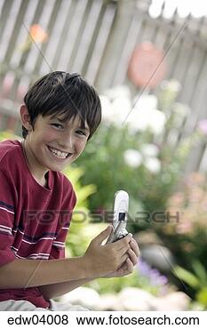 Stock Photo - young boy using 
cell phone. fotosearch 
- search stock 
photos, pictures, 
images, and photo 
clipart