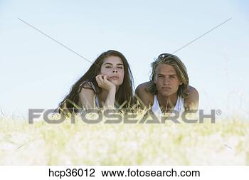 Stock Photo - young couple laying 
in shade. fotosearch 
- search stock 
photos, pictures, 
images, and photo 
clipart