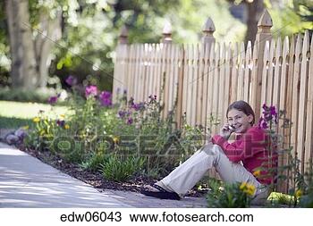 Stock Photo - young girl talking 
on cell phone 
outdoors. fotosearch 
- search stock 
photos, pictures, 
images, and photo 
clipart