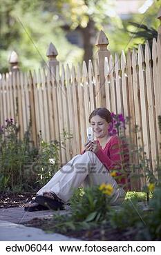 Stock Photo - young girl using 
cell phone outdoors. 
fotosearch - search 
stock photos, 
pictures, images, 
and photo clipart