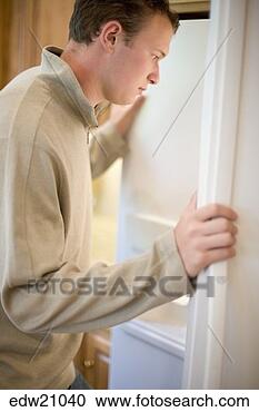 Stock Photography - young man looking 
in refrigerator. 
fotosearch - search 
stock photos, 
pictures, images, 
and photo clipart