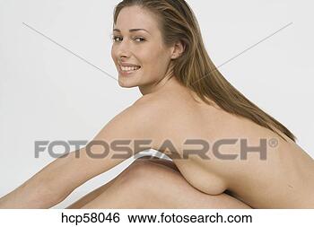 Stock Photo - young nude woman 
leaning over her 
knees. fotosearch 
- search stock 
photos, pictures, 
images, and photo 
clipart