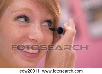 Stock Photography - young woman applying 
mascara. fotosearch 
- search stock 
photos, pictures, 
images, and photo 
clipart