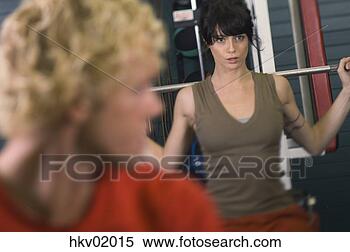 Stock Image - young woman lifting 
weights. fotosearch 
- search stock 
photos, pictures, 
images, and photo 
clipart