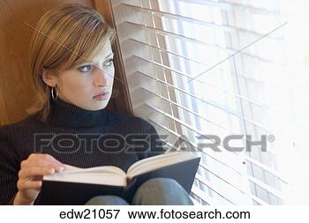 Picture - young woman looking 
out window turning 
page of book. 
fotosearch - search 
stock photos, 
pictures, images, 
and photo clipart