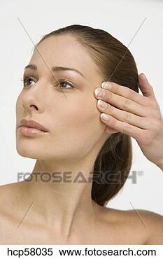 Stock Image - young woman rubbing 
her forehead. 
fotosearch - search 
stock photos, 
pictures, images, 
and photo clipart