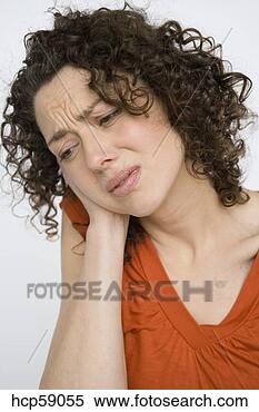Stock Image - young woman rubbing 
her neck. fotosearch 
- search stock 
photos, pictures, 
images, and photo 
clipart