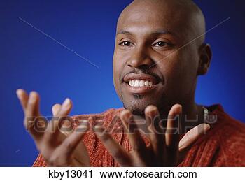 Stock Photography - african man spreading 
out hands. fotosearch 
- search stock 
photos, pictures, 
images, and photo 
clipart