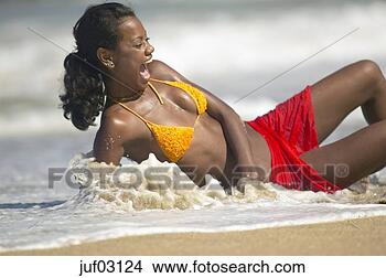 Stock Photo - african woman 
laughing as she 
gets splashed 
with water. fotosearch 
- search stock 
photos, pictures, 
images, and photo 
clipart