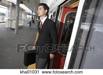 Stock Photography - asian businessman 
departing train. 
fotosearch - search 
stock photos, 
pictures, images, 
and photo clipart