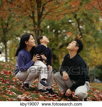 Picture - asian family sitting 
outdoors in autumn. 
fotosearch - search 
stock photos, 
pictures, images, 
and photo clipart