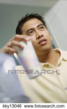 Stock Photo - asian man holding 
cup. fotosearch 
- search stock 
photos, pictures, 
images, and photo 
clipart