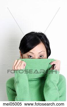 Stock Image - asian woman hiding 
behind shirt. 
fotosearch - search 
stock photos, 
pictures, images, 
and photo clipart