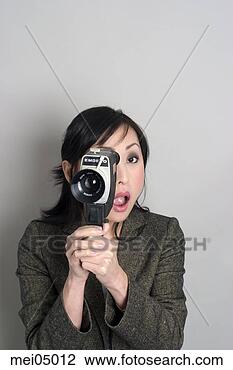 Stock Photo - asian woman looking 
through old-fashioned 
camera. fotosearch 
- search stock 
photos, pictures, 
images, and photo 
clipart