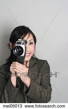 Stock Photo - asian woman looking 
through old-fashioned 
camera. fotosearch 
- search stock 
photos, pictures, 
images, and photo 
clipart