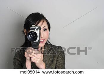 Stock Photo - asian woman looking 
through old-fashioned 
camera. fotosearch 
- search stock 
photos, pictures, 
images, and photo 
clipart