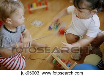 Stock Photo - babies fighting 
over toy. fotosearch 
- search stock 
photos, pictures, 
images, and photo 
clipart