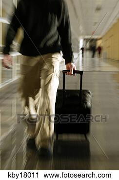 Stock Photography - blurred man walking 
through airport. 
fotosearch - search 
stock photos, 
pictures, images, 
and photo clipart
