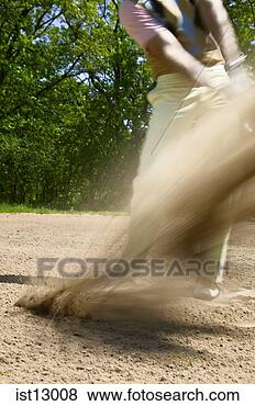 Stock Photo - blurred motion 
of man swinging 
out of bunker. 
fotosearch - search 
stock photos, 
pictures, images, 
and photo clipart