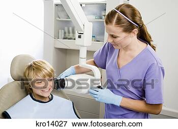 Picture - boy having x-ray 
taken at dentist. 
fotosearch - search 
stock photos, 
pictures, images, 
and photo clipart