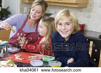 Stock Photography - boy making christmas 
cookies with family. 
fotosearch - search 
stock photos, 
pictures, images, 
and photo clipart