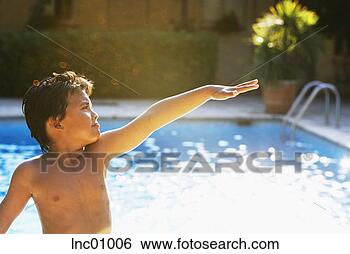 Stock Photo - boy posing next 
to swimming pool. 
fotosearch - search 
stock photos, 
pictures, images, 
and photo clipart
