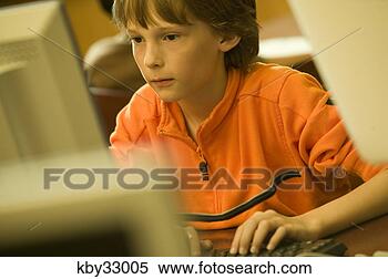 Stock Image - boy using a computer. 
fotosearch - search 
stock photos, 
pictures, images, 
and photo clipart