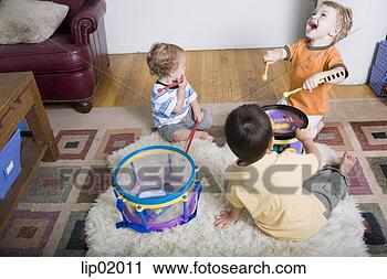 Stock Photography - boys playing with 
toy drums. fotosearch 
- search stock 
photos, pictures, 
images, and photo 
clipart