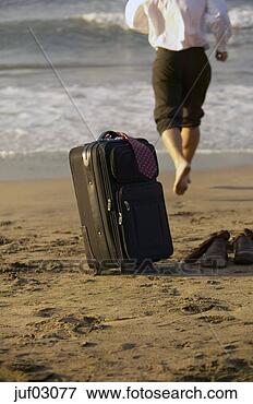 Picture - businessman abandoning 
suitcase to swim 
in ocean. fotosearch 
- search stock 
photos, pictures, 
images, and photo 
clipart