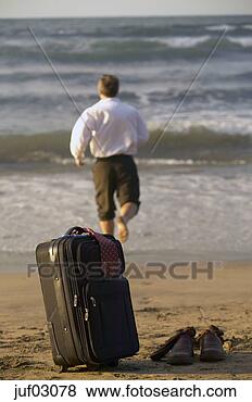 Stock Photo - businessman abandoning 
suitcase to swim 
in ocean. fotosearch 
- search stock 
photos, pictures, 
images, and photo 
clipart