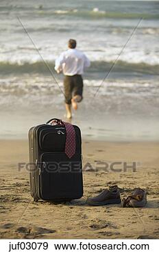 Stock Photograph - businessman abandoning 
suitcase to swim 
in ocean. fotosearch 
- search stock 
photos, pictures, 
images, and photo 
clipart