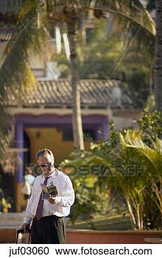 Stock Photography - businessman reading 
tourist magazine. 
fotosearch - search 
stock photos, 
pictures, images, 
and photo clipart