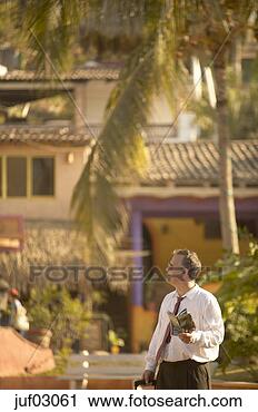 Stock Photography - businessman reading 
tourist magazine. 
fotosearch - search 
stock photos, 
pictures, images, 
and photo clipart