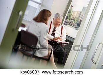 Picture - businessman talking 
to colleague in 
office. fotosearch 
- search stock 
photos, pictures, 
images, and photo 
clipart