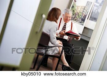Stock Photography - businessman talking 
to colleague in 
office. fotosearch 
- search stock 
photos, pictures, 
images, and photo 
clipart