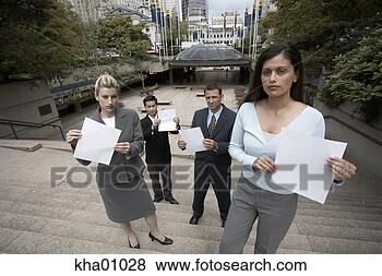 Stock Photo - businesspeople 
holding sheets 
of paper. fotosearch 
- search stock 
photos, pictures, 
images, and photo 
clipart