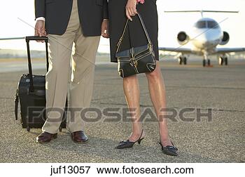Picture - businesspeople 
standing on runway. 
fotosearch - search 
stock photos, 
pictures, images, 
and photo clipart