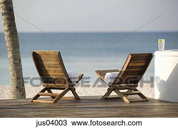 Stock Photo - chairs and towels 
on tropical beach. 
fotosearch - search 
stock photos, 
pictures, images, 
and photo clipart