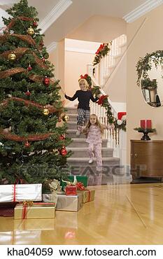 Stock Photograph - children rushing 
to open christmas 
presents. fotosearch 
- search stock 
photos, pictures, 
images, and photo 
clipart