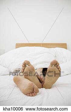 Stock Photo - close up of barefeet, 
couple cuddling 
in bed. fotosearch 
- search stock 
photos, pictures, 
images, and photo 
clipart