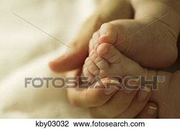 Stock Photo - close up of mother 
cradling newborn's 
feet. fotosearch 
- search stock 
photos, pictures, 
images, and photo 
clipart