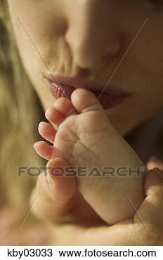 Stock Photo - close up of mother 
kissing newborn's 
feet. fotosearch 
- search stock 
photos, pictures, 
images, and photo 
clipart