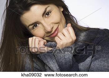Stock Photo - close up of woman 
smiling, tugging 
sweater. fotosearch 
- search stock 
photos, pictures, 
images, and photo 
clipart