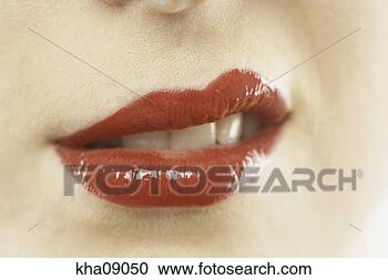Stock Photography - close up of woman's 
glossy red lips, 
upper left raised. 
fotosearch - search 
stock photos, 
pictures, images, 
and photo clipart